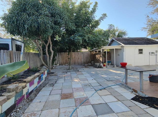 view of patio / terrace featuring an outdoor structure and a wooden deck