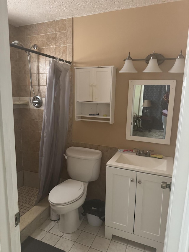 bathroom featuring tile patterned flooring, vanity, walk in shower, toilet, and a textured ceiling