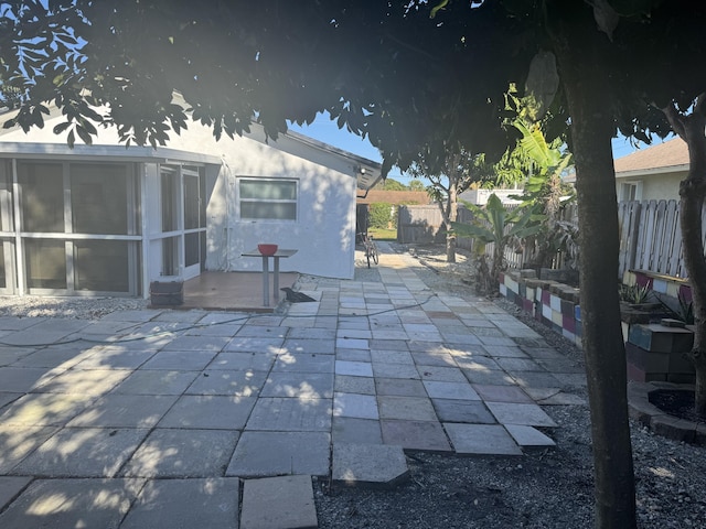 view of patio with a sunroom