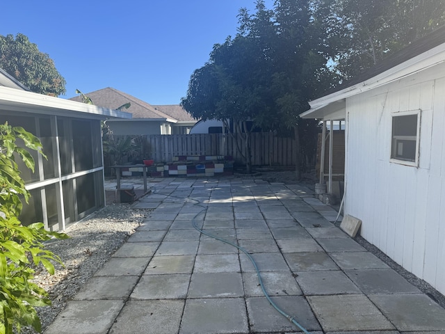 view of patio featuring a sunroom