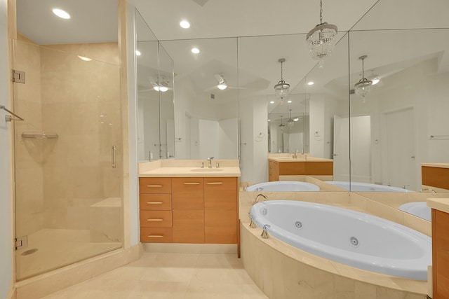 bathroom featuring tile patterned flooring, vanity, and separate shower and tub