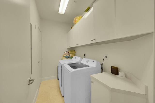 laundry room with cabinets and washing machine and clothes dryer