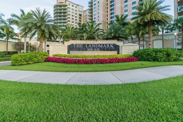 community / neighborhood sign with a lawn