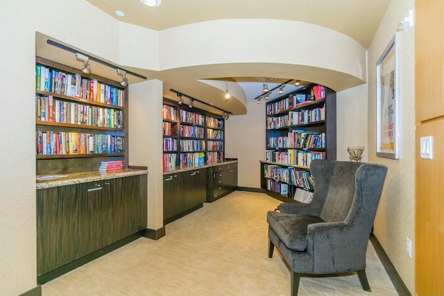 living area featuring light carpet