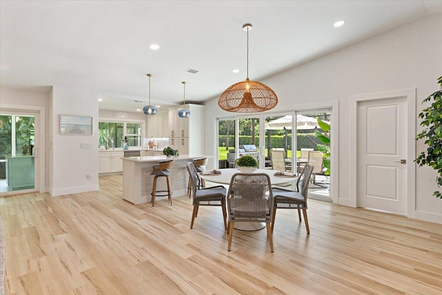 dining area with a healthy amount of sunlight, light hardwood / wood-style floors, and sink