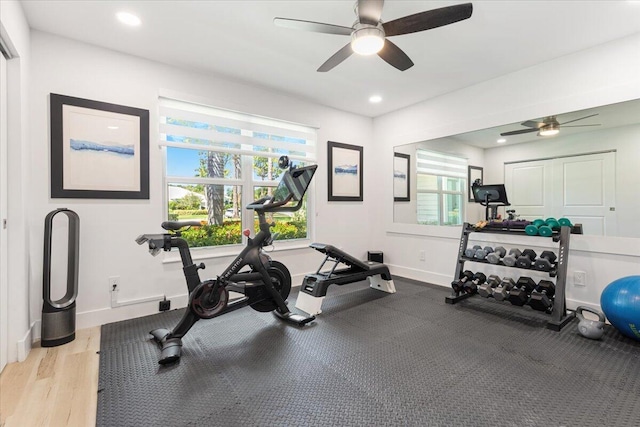 workout room featuring ceiling fan and light hardwood / wood-style floors