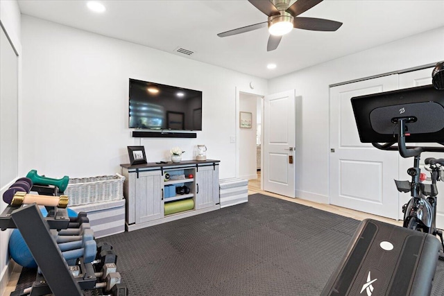 exercise room with ceiling fan