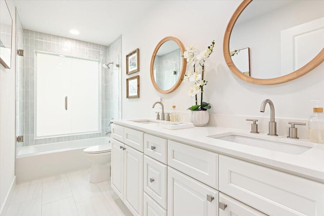 full bathroom featuring tile patterned flooring, tiled shower / bath combo, toilet, and vanity