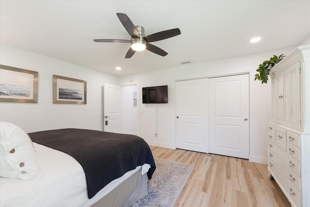 bedroom with light hardwood / wood-style floors and ceiling fan