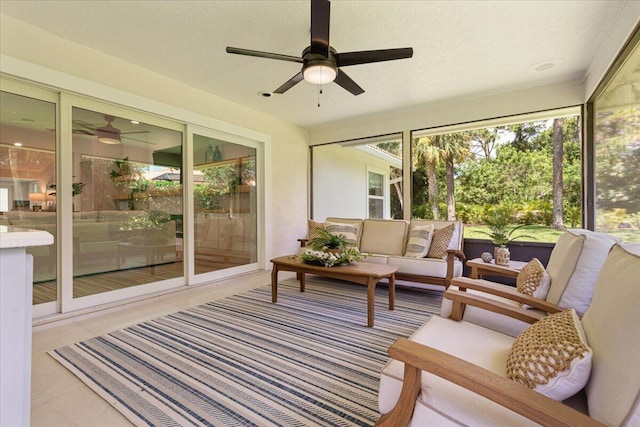 sunroom / solarium featuring ceiling fan