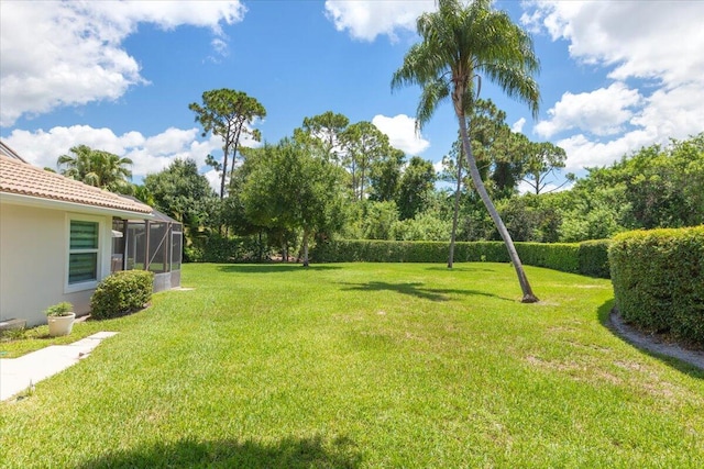 view of yard featuring glass enclosure