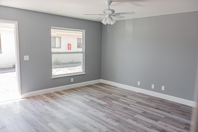 empty room with ceiling fan and light wood-type flooring