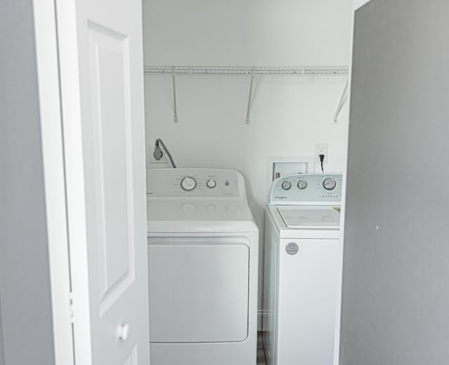 clothes washing area featuring separate washer and dryer