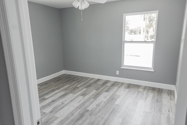 empty room featuring ceiling fan and light wood-type flooring