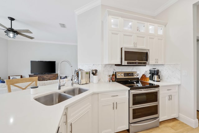 kitchen with white cabinets, sink, and stainless steel appliances