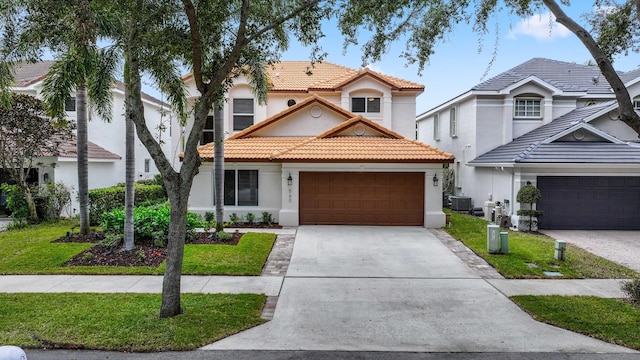 mediterranean / spanish-style house featuring a front lawn and cooling unit