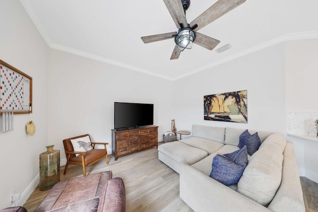 living room with light hardwood / wood-style floors, ceiling fan, and crown molding