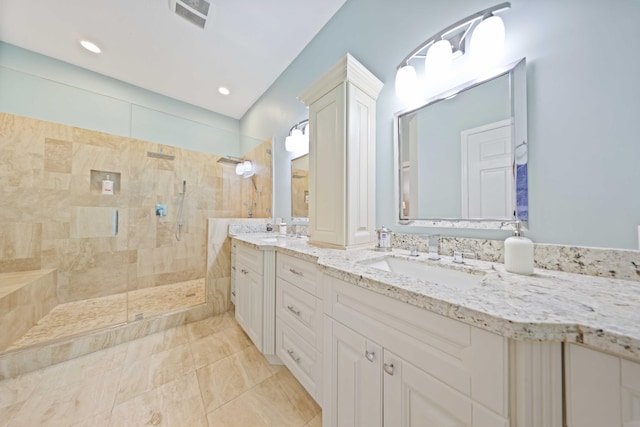 bathroom featuring vanity and tiled shower