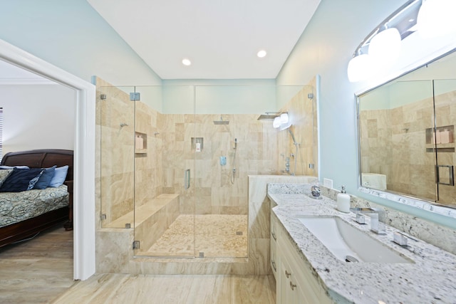 bathroom featuring vanity and an enclosed shower