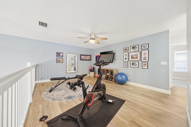 exercise room featuring hardwood / wood-style flooring and ceiling fan