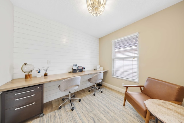 office area with light hardwood / wood-style flooring and built in desk