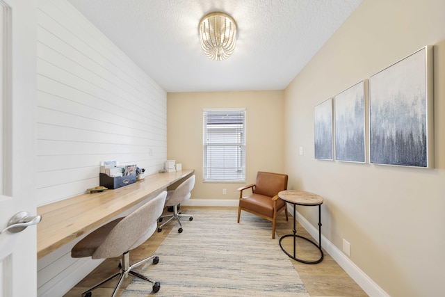 office space with a textured ceiling and light wood-type flooring