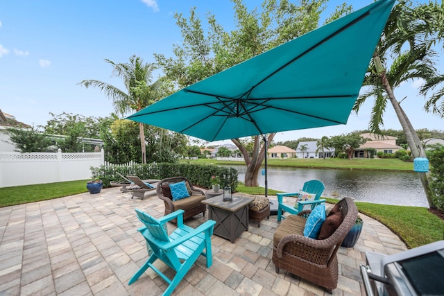 view of patio featuring a water view and an outdoor fire pit