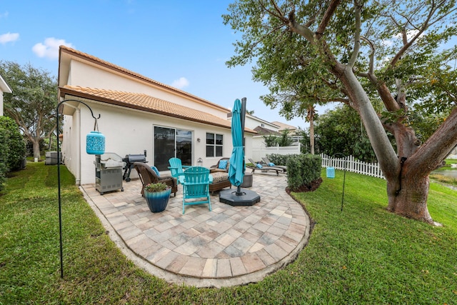 rear view of property with a yard and a patio