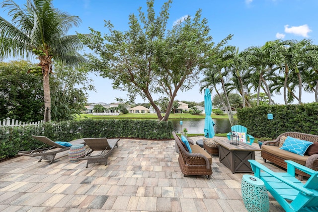 view of patio / terrace with outdoor lounge area and a water view