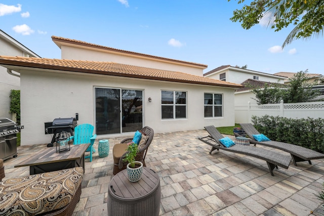 back of house with a patio area and an outdoor hangout area