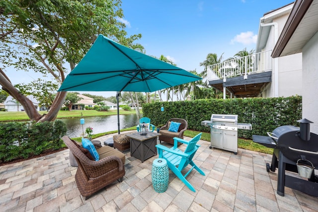 view of patio / terrace featuring a water view and grilling area