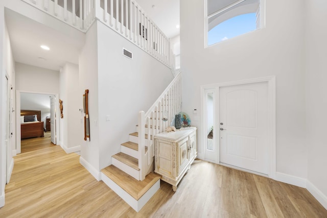 entrance foyer with a high ceiling and light wood-type flooring