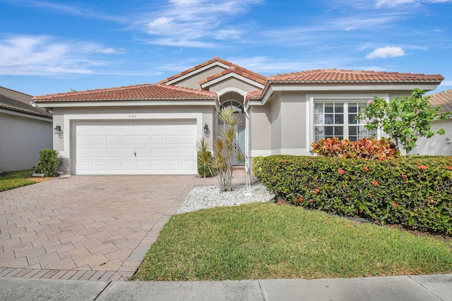 mediterranean / spanish-style home with a garage