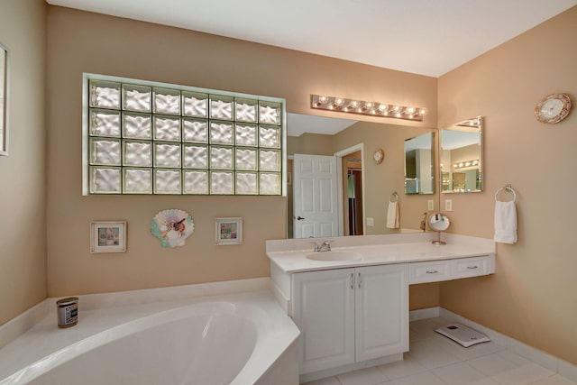 bathroom with tile patterned flooring, vanity, and a washtub