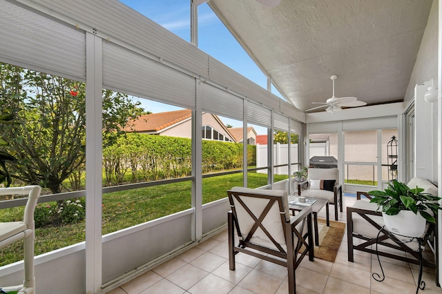 sunroom with ceiling fan and lofted ceiling