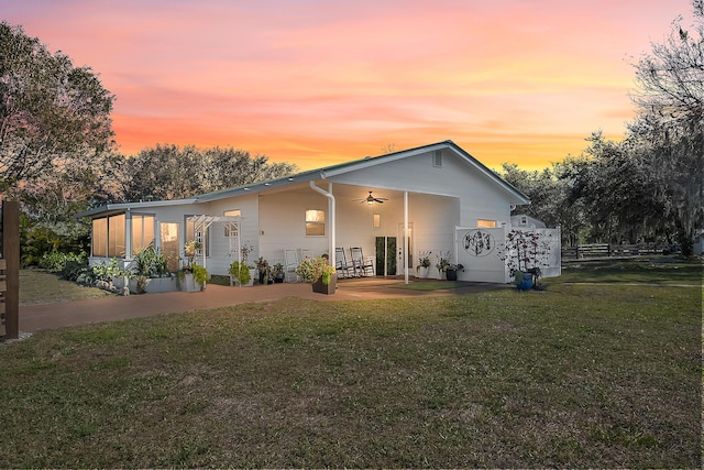 back house at dusk with a yard