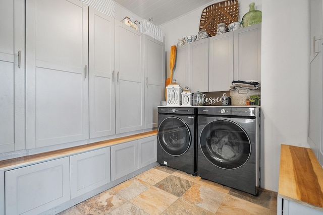 washroom featuring cabinets and independent washer and dryer