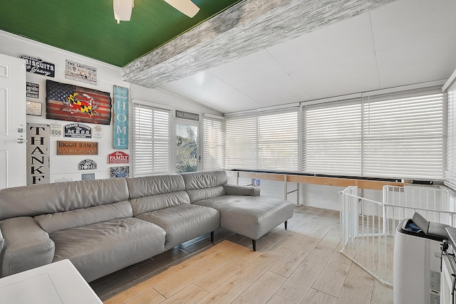 living room with ceiling fan and lofted ceiling