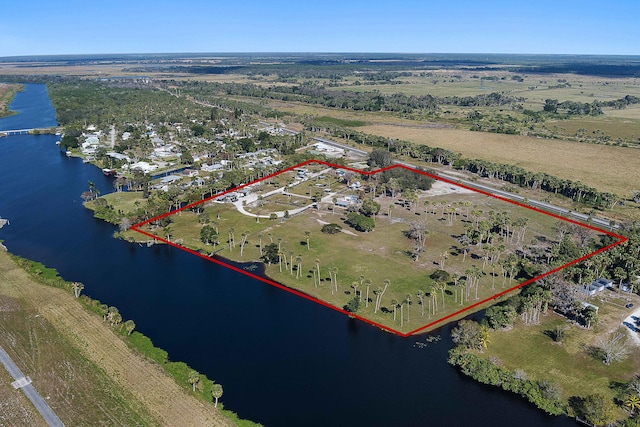 birds eye view of property with a rural view and a water view