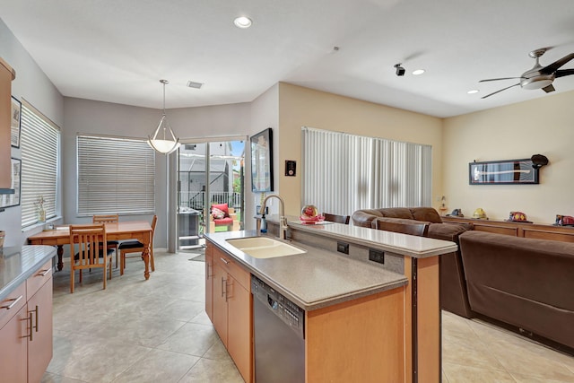 kitchen featuring a center island with sink, sink, hanging light fixtures, stainless steel dishwasher, and ceiling fan