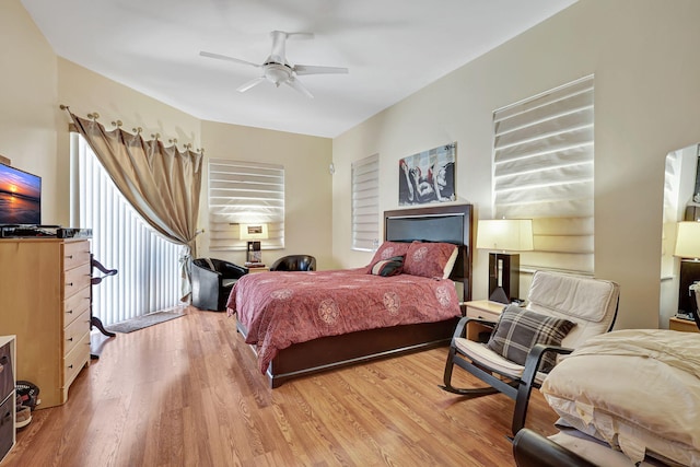 bedroom with light hardwood / wood-style floors and ceiling fan