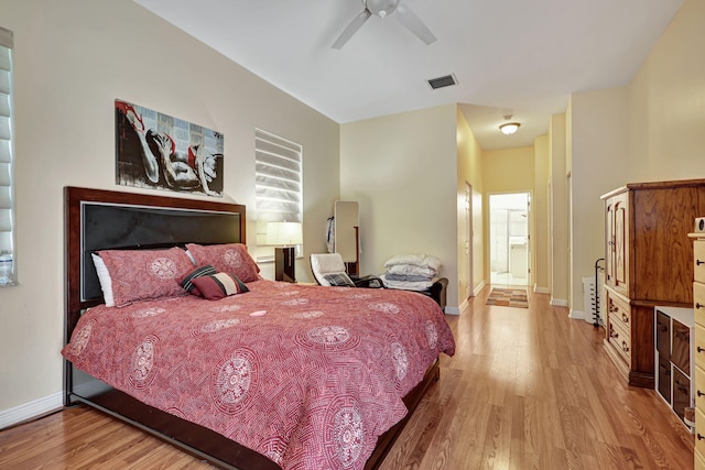 bedroom featuring connected bathroom, light hardwood / wood-style floors, and ceiling fan