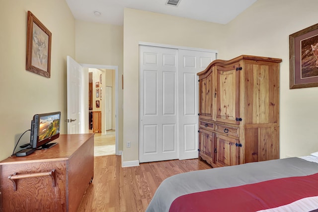 bedroom featuring light hardwood / wood-style flooring and a closet