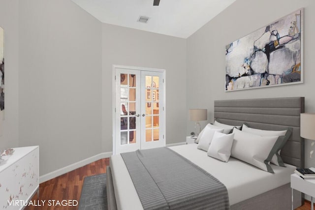 bedroom featuring french doors and dark wood-type flooring