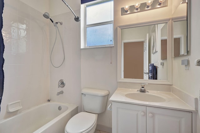 full bathroom with vanity, toilet, and tiled shower / bath