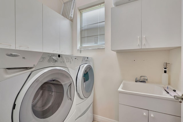 laundry area with cabinets, sink, and washing machine and clothes dryer