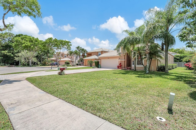 view of front of home with a garage and a front lawn