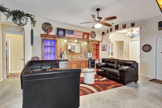 living room featuring ceiling fan with notable chandelier, light tile patterned flooring, and beverage cooler