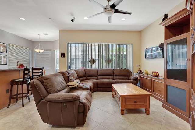 tiled living room with ceiling fan