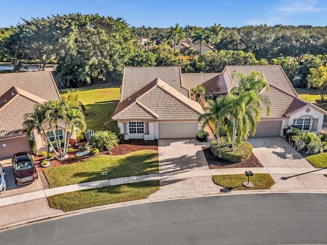 view of front of home with a garage and a front lawn